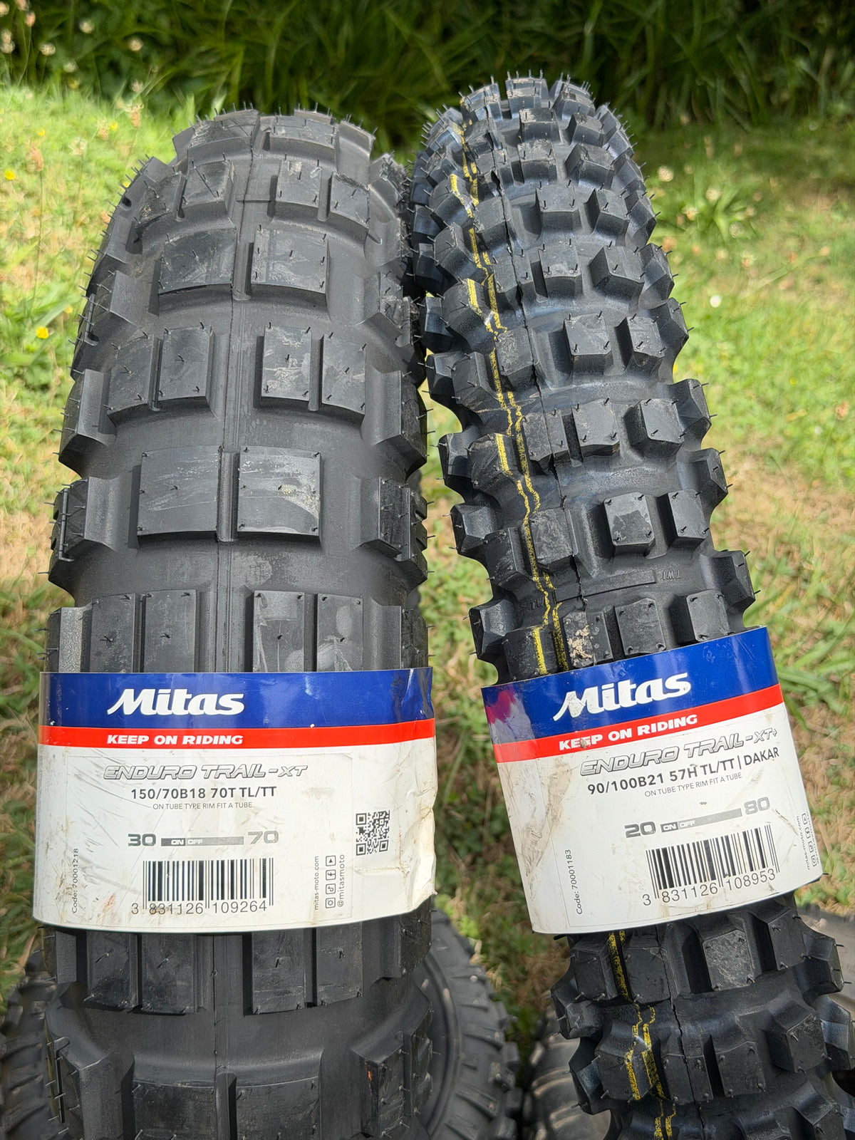 Mitas Enduro Trail XT+ Dakar tyre pair close-up — 90/100-21 front and 150/70B18 rear enduro tread pattern